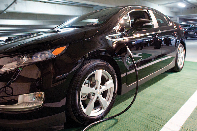 A electric vehicle charging in a parking garage